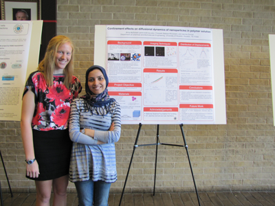 Anna with her
		     poster on nanoparticle diffusion and her
		     graduate student mentor Firoozeh.