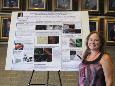 Liz with her
		     poster on bacterial fibers.